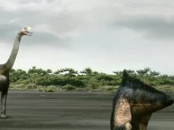 Wide Shot hand-held - A Brachiosaurus swings its tail to defend against an approaching dinosaur in a computer-generated animation. / Washington, DC, USA Stock Footage