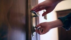 Young woman locking the door close up. Stock Footage
