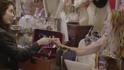 Young woman buying cowgirl boots hands credit card to cashier and leaves signature on tablet touchscreen Stock Footage