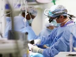 Doctors performing surgery in operating room Stock Footage