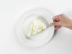 CU Woman hand entering setting down round white plate with coconut cream, banana cream slice of dessert pie / Omaha, Nebraska, United States Stock Footage