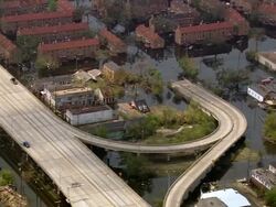 Aerial flooded residential area / zoom in submerged I-10 highway / New Orleans, Louisiana Stock Footage