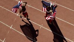 Track & field athletes holding American flags and hugging Stock Footage