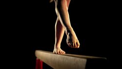 SLO MO LD Female gymnast on balance beam Stock Footage