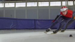 MS SLO MO Short track speed skaters making turn during race on track in arena Stock Footage