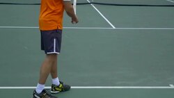 A experienced tennis player serving to a beginner tennis player. Stock Footage
