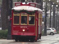 MS Tram running and people walking on road during rain / New Orleans, United States Stock Footage