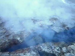 MS Dark blue geyser pool bubbling with steam coming out / Geiser del Tatio, Atacama desert, Chile Stock Footage