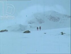 Two Norwegians cross-country skiing in the snowy mountains, 1970s. They collide and fall over. Child skis towards camera. Stock Footage