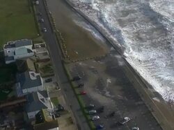 Aerials of Waves Crashing Over Sea Defence Walls News Clip