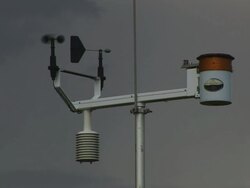 CU Shot of automated weather observation station with wind vane and anemometer and stormy sky behind / Kansas, United States Stock Footage
