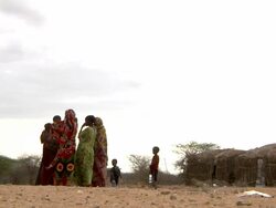 Family next to straw tents Stock Footage