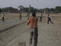 WS Young Boys Playing Cricket in Dirt Field / India Stock Footage