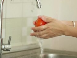 Hands washing tomato Stock Footage