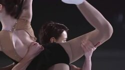 SLO MO Young ice skating pair doing rotational dance lift Stock Footage