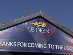 Fans walk towards Arthur Ashe Stadium at the USTA Center Stock Footage