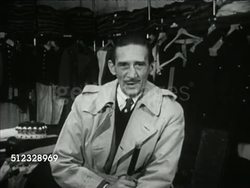 1953: MOSS BROTHERS: Angled WS Moss Brothers menswear clothing store, CU 'Moss Bros & Co Ltd' sign. Westbrook Van Voorhis inside store talking about variety of clothing, here a peer is being fitting for Robes of State, Westbrook moving in to watch. Instructional Video