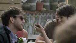 Group of friends at outdoor caf_ look at smartphone and laugh Stock Footage