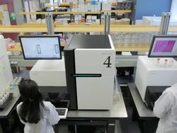 MS POV Lab technicians working on HiSeq2000s DNA sequencers / Vancouver, BC, Canada Stock Footage