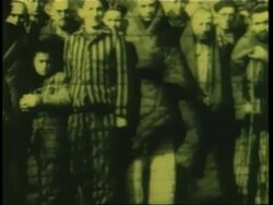 Polish Jews walk in the Auschwitz concentration camp and remains from victims cover the camp's grounds. News Clip