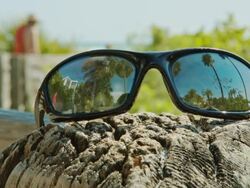 Sunglasses in foreground reflection of palm trees Summer Stock Footage