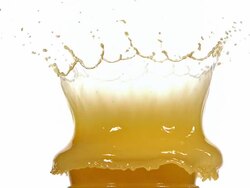 CU SLO MO Golfball falling and splashing into orange juice against white background / Vieux Pont, Normandy, France Stock Footage