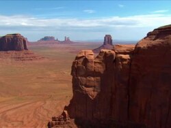 Aerial sweeping view expansive desert valley of buttes / Monument Valley Stock Footage