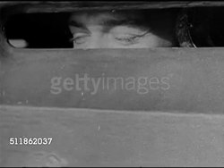 1942: PACIFIC FRONT: Behind US Soldiers on ship. CU Eyes of soldier watching from behind metal plating. XWS Smoke rising from unidentified island. MS US Soldier firing Browning machine gun. Soldiers waiting at water's edge. Pacific Theater, WWII. Instructional Video