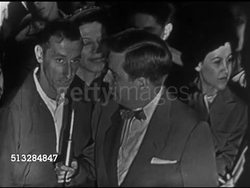 1952: NEW YORK CITY: TIMES SQUARE: NIGHT: HA WS Times Square cityscape,TD Crowd of people. VOX POPS: Unidentified host w/ mic & people asking questions for Eisenhower: Position on Labor Law?, FEPC & Taft Hartley?, Reduce taxes like Taft promised? Instructional Video