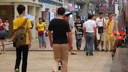 People in busy Shenzhen city centre on phones News Clip