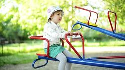 Girl playing on seesaw. Stock Footage