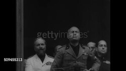 1936: THE THIRTIES: Fascist dictator Benito Mussolini (Il Duce) gesturing, speaking (no SOT). MS Hitler speaking at rally (no SOT). German, Italian, LA French troops marching.  WWII. Instructional Video