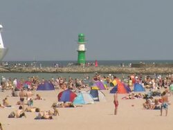 WS Crowded beach and Ferry ship moving on river / Warnemuende near Rostock, Mecklenburg-Western Pomerania, Germany Stock Footage