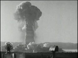 A mushroom cloud rises from an atomic bomb test site in Nevada. News Clip