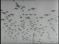 Hundreds of soldiers parachute from airplanes during World War II. News Clip