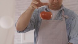 Chef cutting tomato in the kitchen Stock Footage