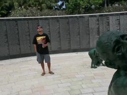 Long shot of tourist observing memorial statue. Stock Footage