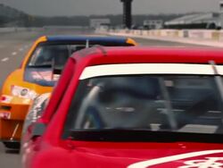 TS CU Two racecars competing for first position along racetrack and driving around curve / Long Pond, Pennsylvania, USA Stock Footage