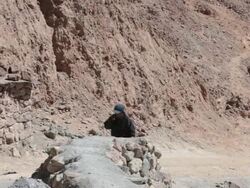 MS Shot of man walking and truck moving on road at Potosi mine / Potosi, Bolivia Stock Footage