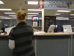 MS Job seeker woman standing at counter is assisting by clerk at state run job center / Jackson, Michigan, United States  Stock Footage