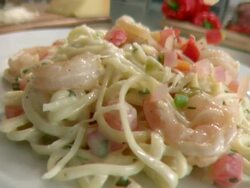 MS DS SLO MO Shrimp alfredo pasta with tomatoes and onions fall onto pasta / Los Angeles, CA, United States Stock Footage