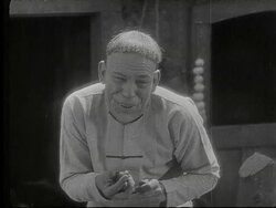 Lon Chaney Sr as Chinese man gives boy candy Stock Footage