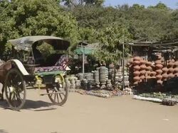 MS Shot of Horse carriage driving past ceramic shop / Bagan, Mandalay Division, Myanmar Stock Footage
