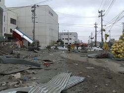 Destruction caused by tsunami after magnitude 9 Tohoku earthquake, north east Japan, March 2011. Fire crews walk through debris strewn streets in Ishinomaki City port, Miyagi Prefecture Stock Footage