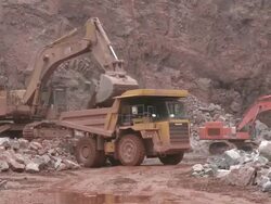 MS Excavator truck loading stone in another truck at quarry / Taben-Rodt, Rhineland-Palatinate, Germany Stock Footage