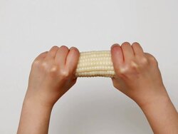 CU Hands cutting Corn in half / Seoul, South Korea Stock Footage