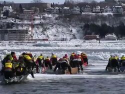 WS Ice canoe racing across the St. Lawrence River at Quebec Winter Carnival / Quebec City, Quebec, Canada Stock Footage