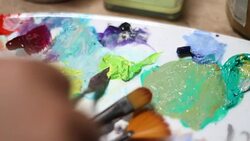 The artist mixes paint on the palette Stock Footage