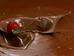 HD Super Slow-Mo: Few Strawberries Splashing Into Chocolate Stock Footage