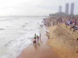 MS T/L Shot of families playing in surf on a weekend at beach of Galle Face Green at dusk / Colombo, Western Province, Sri Lanka Stock Footage